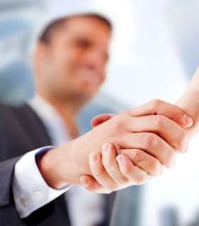 Business man closing a deal with a handshake_818-TUMB
